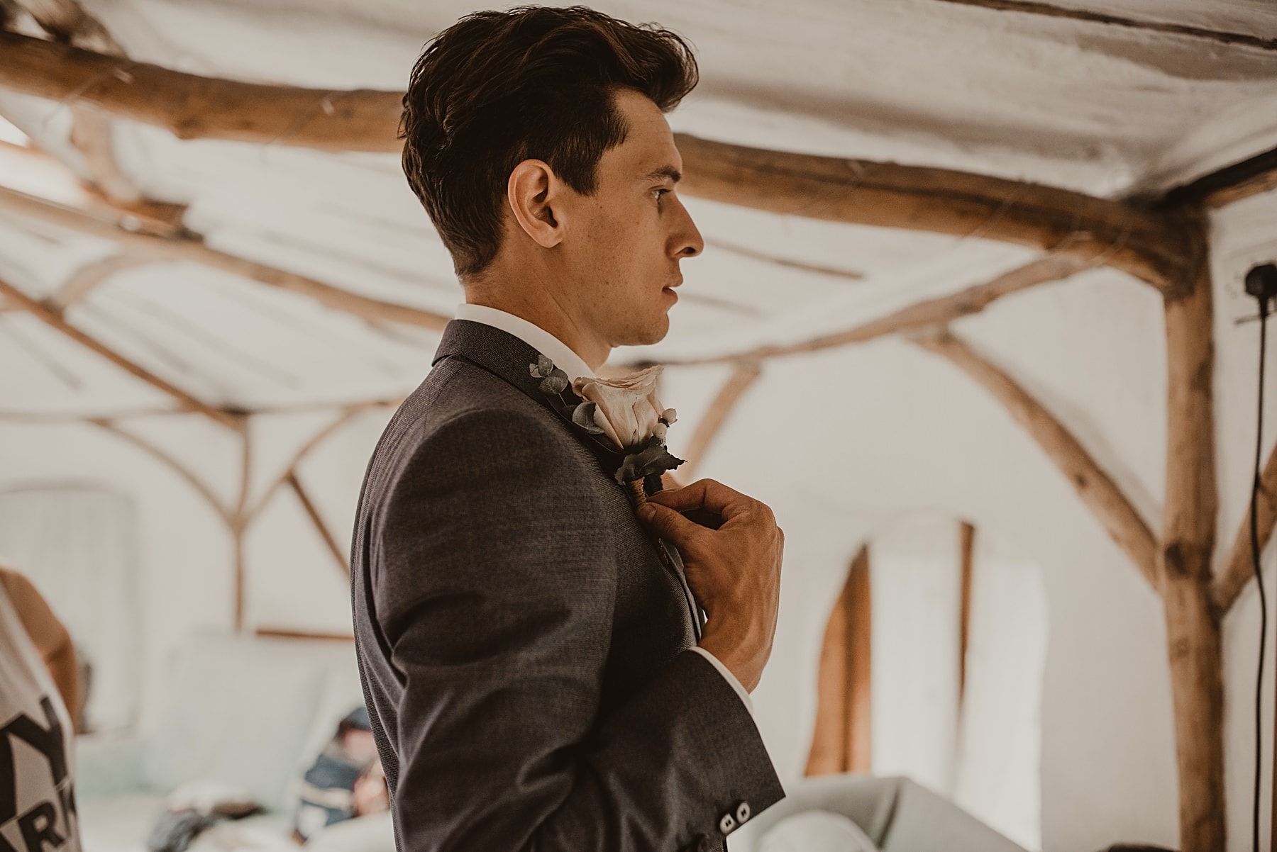 Groom putting on button hole