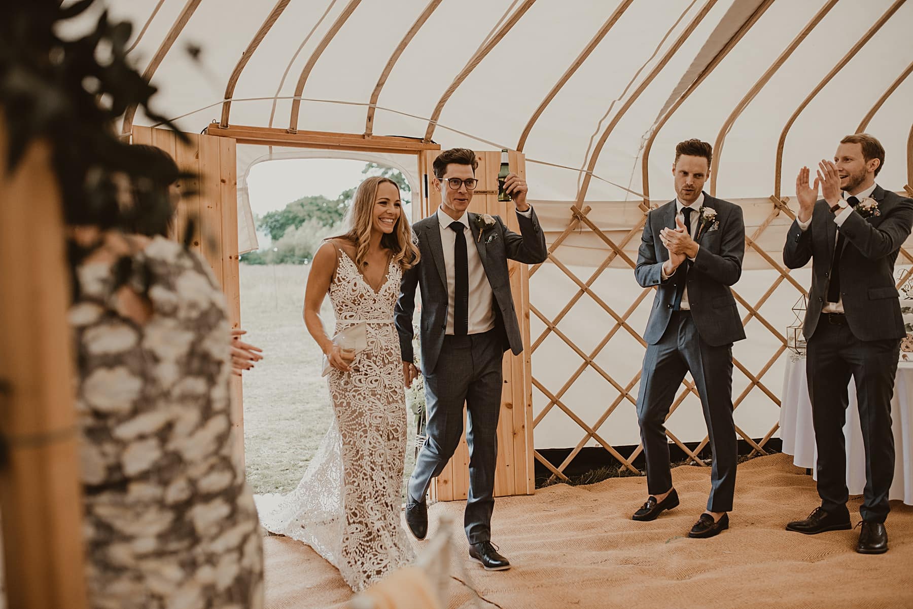 Bride and groom entering yurt