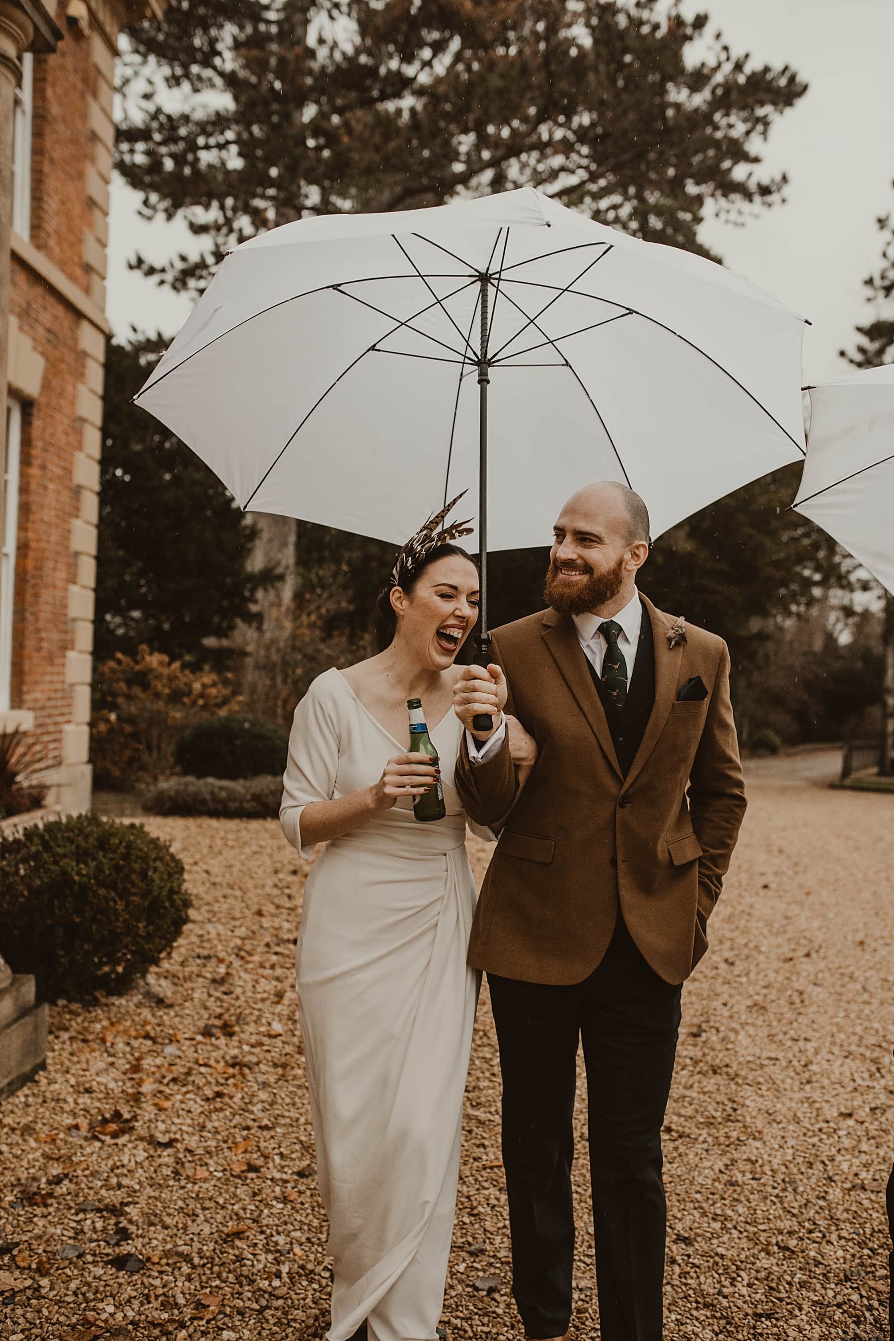 Bride and groom walking in rain