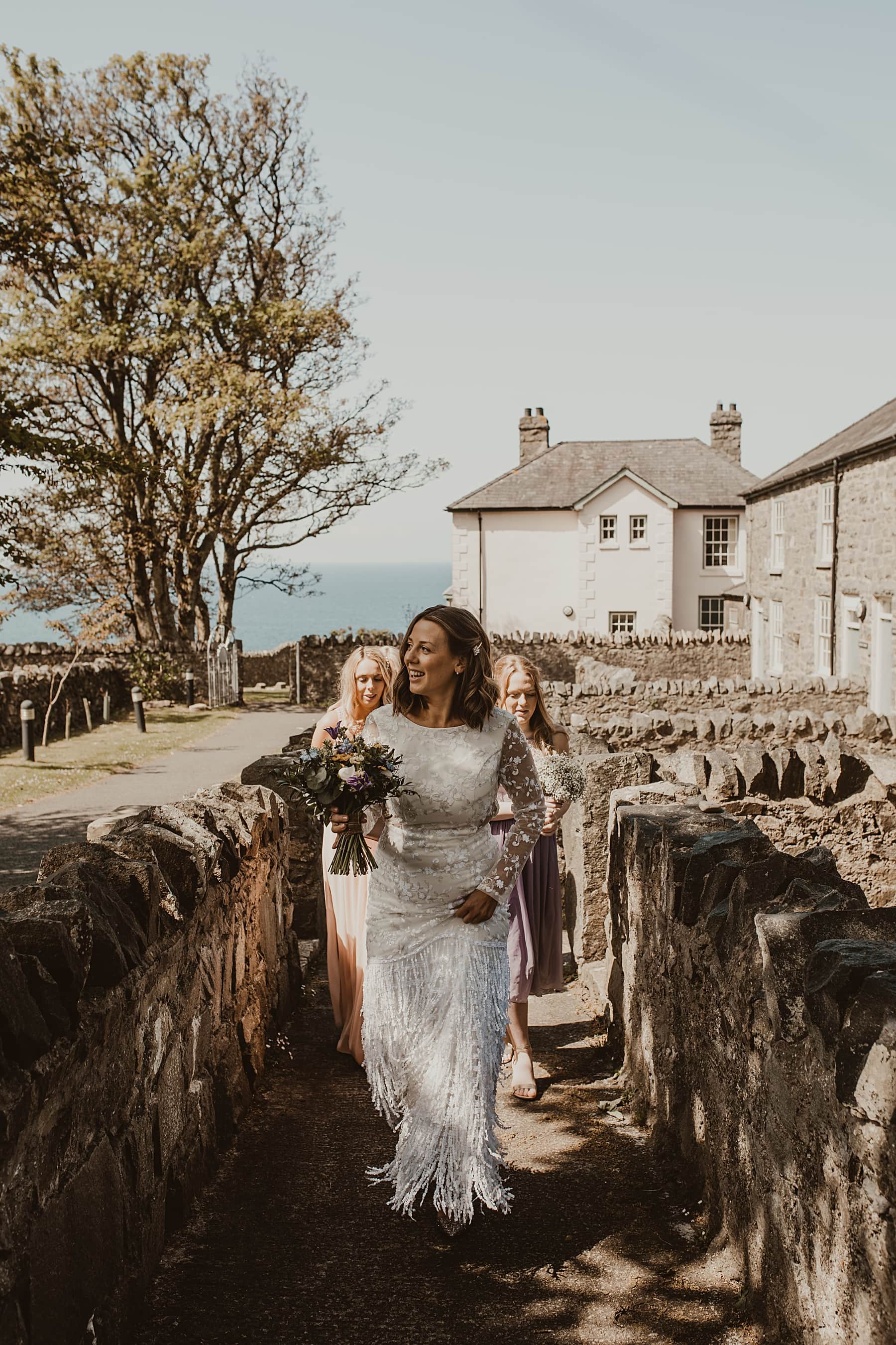 Bride and bridesmaids walking to the ceremony