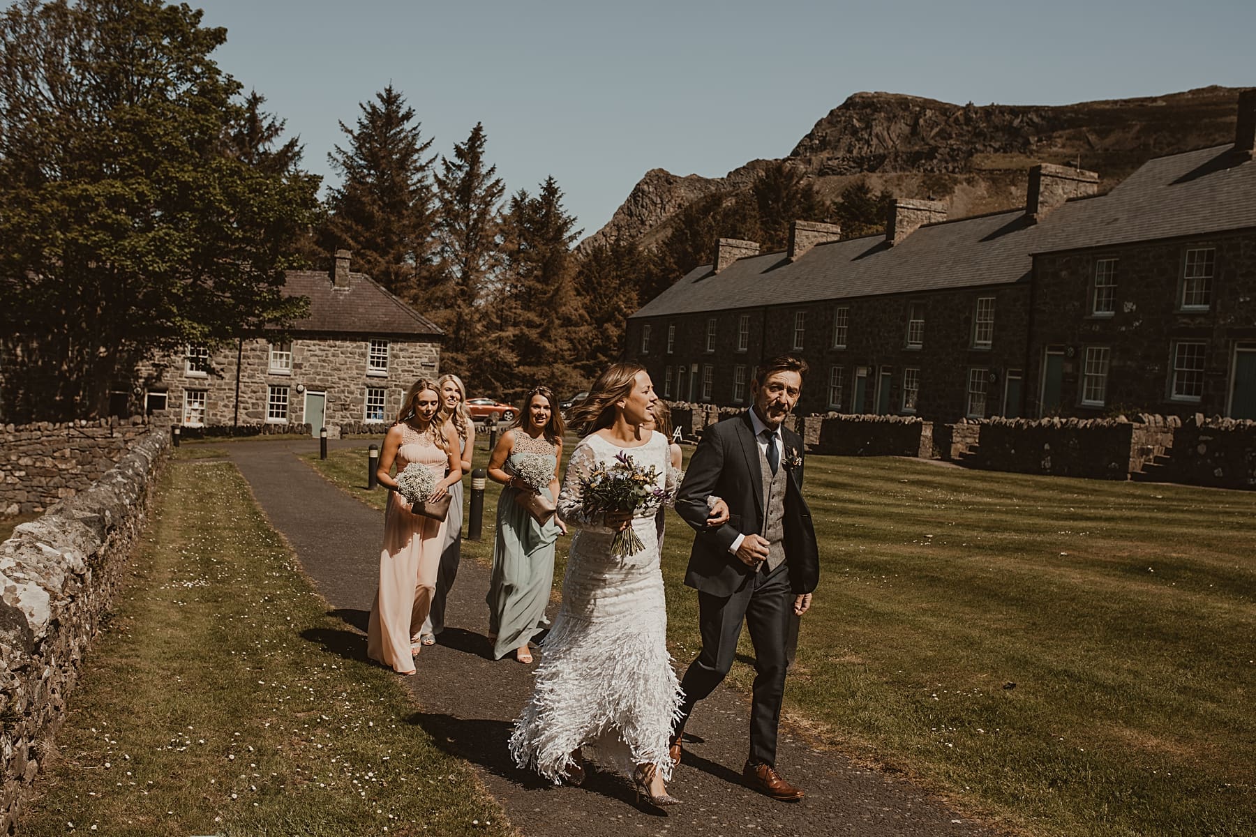 Bride and bridal party walking to ceremony