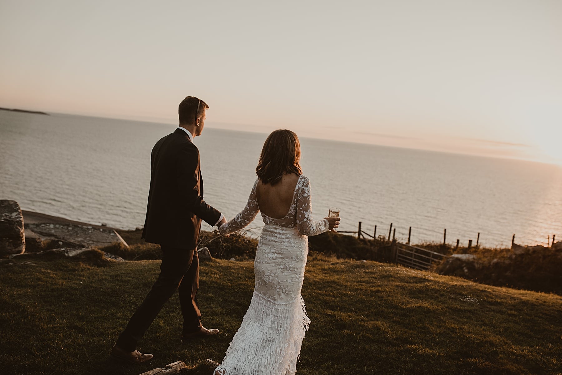 Couple walking into sunset 