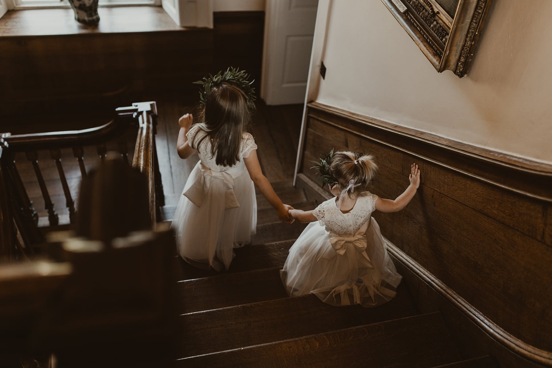 Flower girls walking down staircase at Iscoyd Park